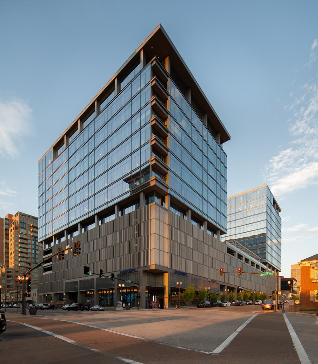 Dusk photograph showcasing glazing on a highrise building built for commercial and retail use