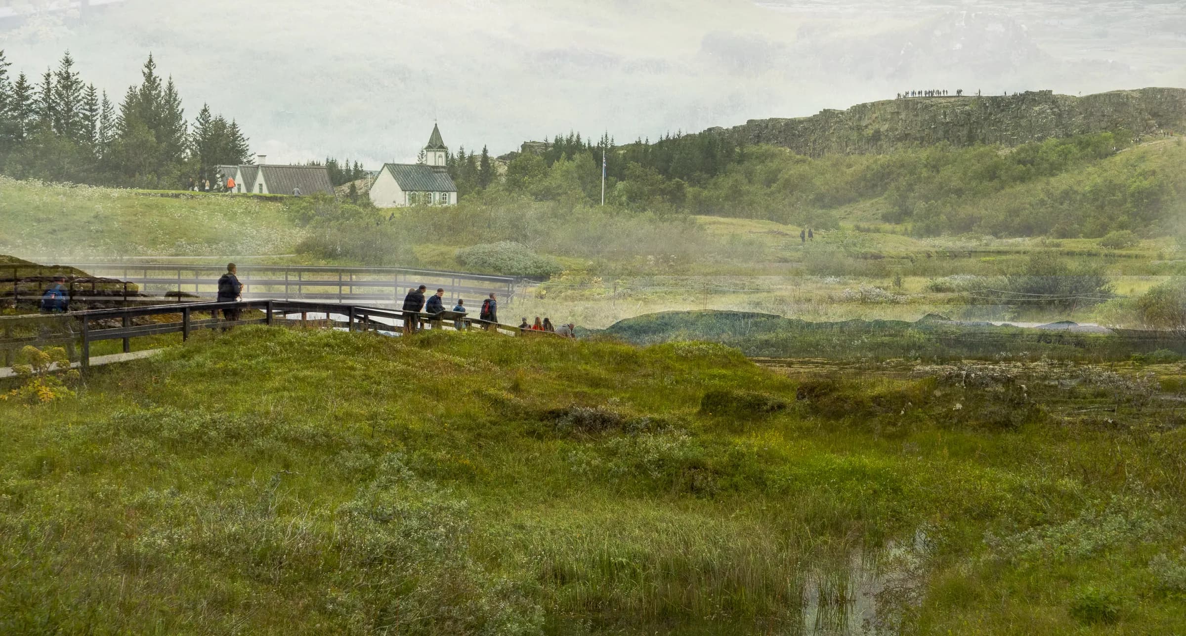 Layered Icelandic landscape with a small white church, distant cliffs, wetlands, and overlapping figures walking along a wooden path.
