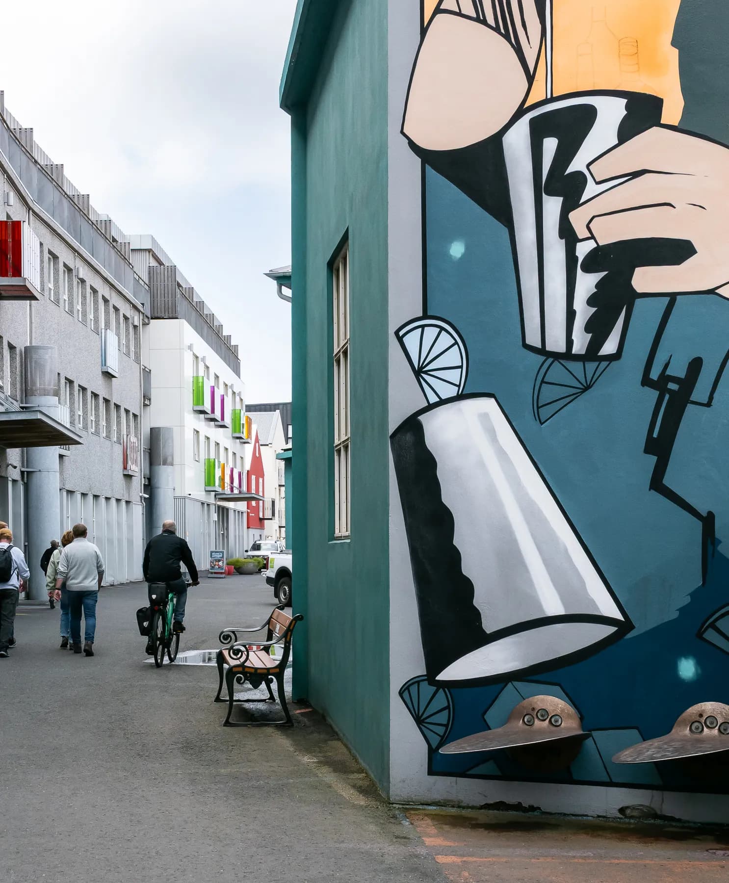 Street scene in Reykjavik with a large mural painted on the side of a building.